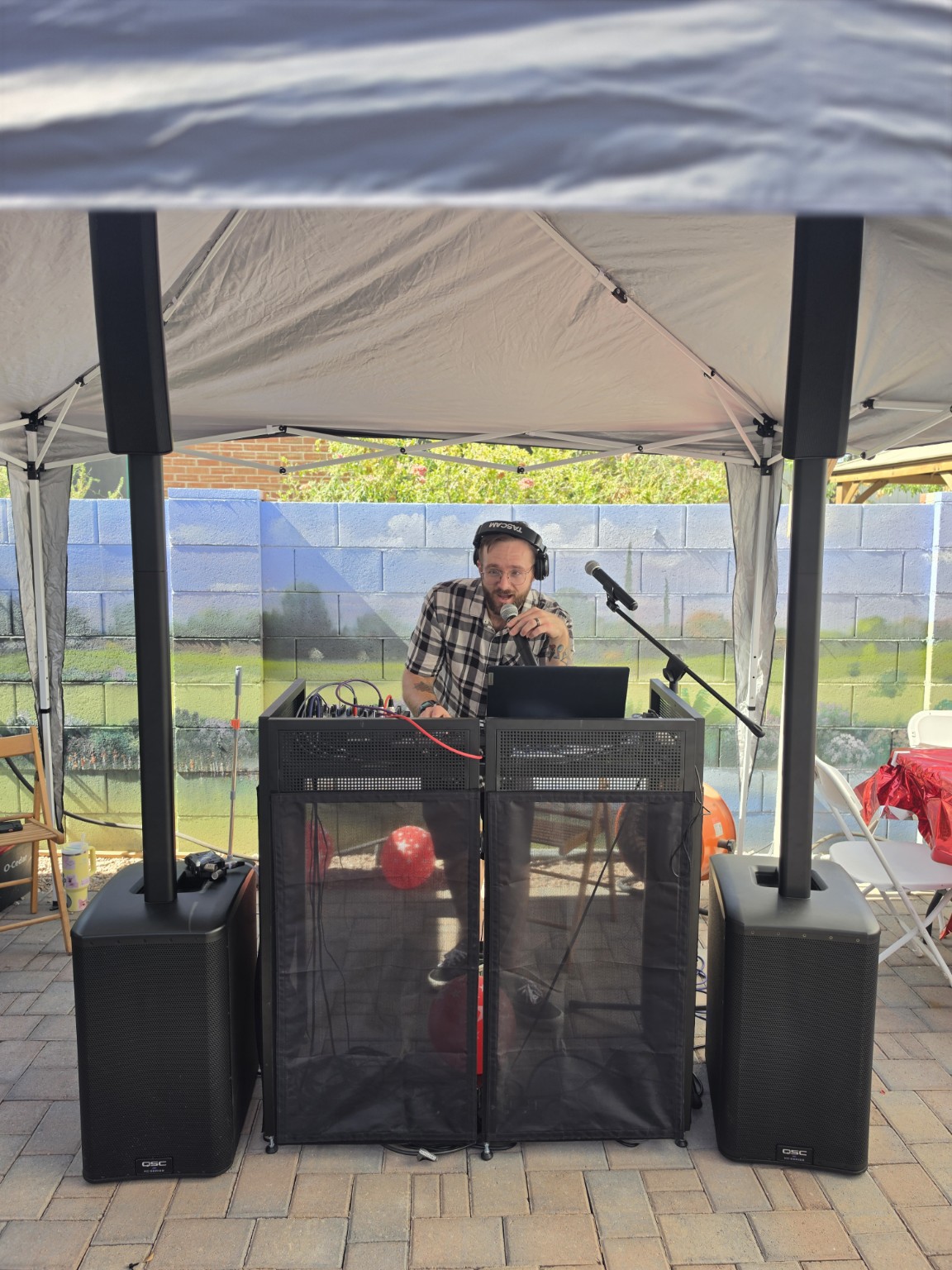 Steady Hands DJ and MC at a full outdoor audio setup